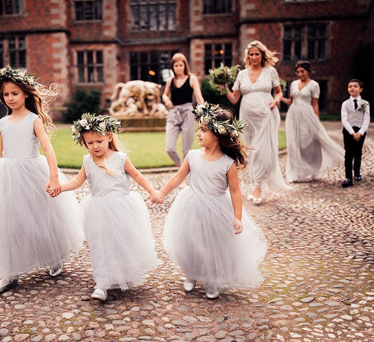 Flower girls in grey tulle dresses and flower crowns