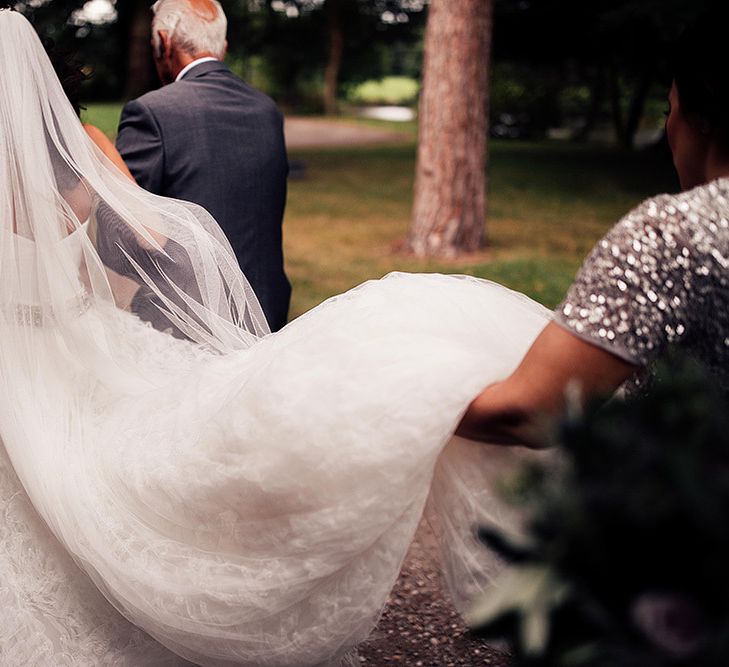 Bride in ruffle skirt and long wedding veil