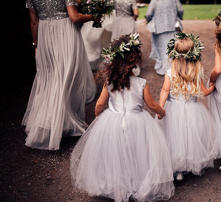 Cute flower girls in silver dresses and flower crowns