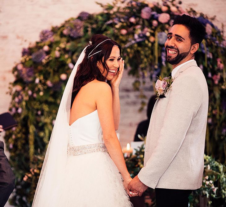 Bride and groom laughing at the altar of their Dorfold Hall wedding ceremony