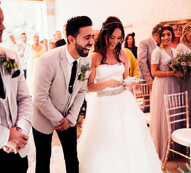 Groom laughing at the altar during wedding ceremony