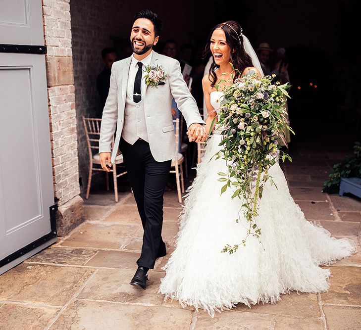 Bride in separates and groom in grey blazer and matching waistcoat