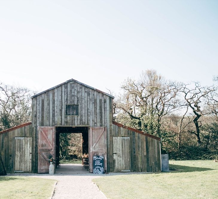 Nancarrow Farm Cornwall Wedding With Images From Dale Weeks &amp; Bride In Maggie Sottero With Wild Flower Bouquet &amp; Hand Knitted Flower Girl Outfit