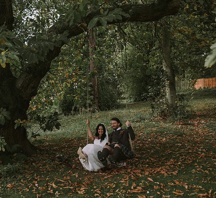 Swing Portrait | Bride in Enzoani Gown | Groom in Tartan Kilt | Autumnal Scottish Woodland Wedding at Fernie Castle | Maureen Du Preez Photography