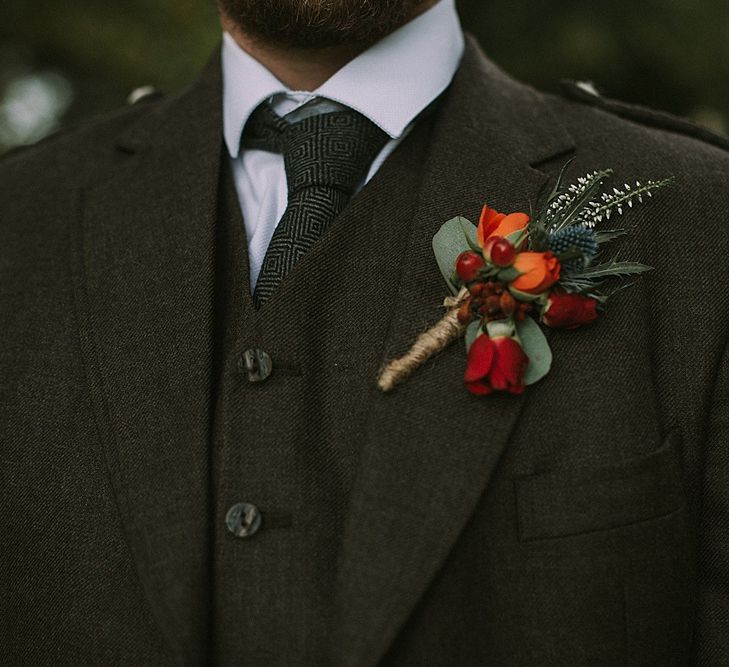 Deep Red &amp; Orange Buttonhole | Groom in Tartan Kilt &amp; Tweed Jacket | Autumnal Scottish Woodland Wedding at Fernie Castle | Maureen Du Preez Photography