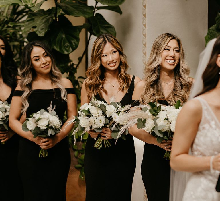 Bridesmaids watch on at the ceremony