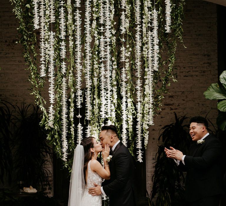 White wedding flowers at altar