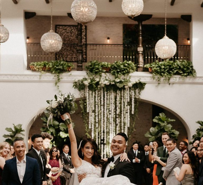 Bride and groom celebrate at black and white colour scheme wedding