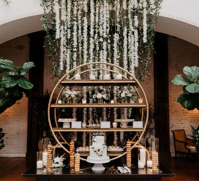 White wedding cake with gold  dessert stand