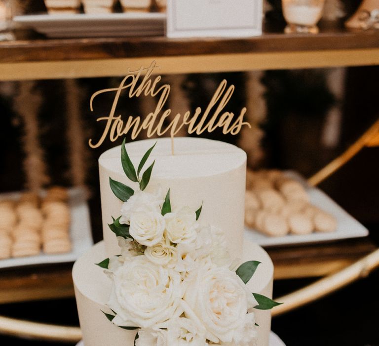 White wedding cake with personalised cake topper