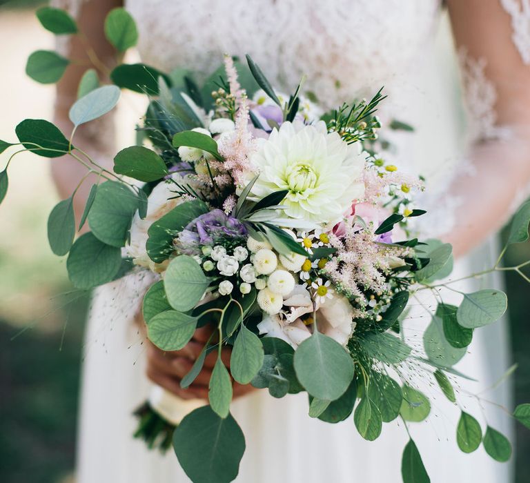 Bridal Bouquet of White, Soft Pink, Purple and Yellow Flowers with Greenery | Bride in Long Sleeved Anna Kara Wedding Dress with Lace Bodice and Soft Skirt |  Britten Weddings Floor Length Veil | Puglian Countryside Wedding with Fairy Light Altar and Olive Grove Aperitivo | Figtree Wedding Photography