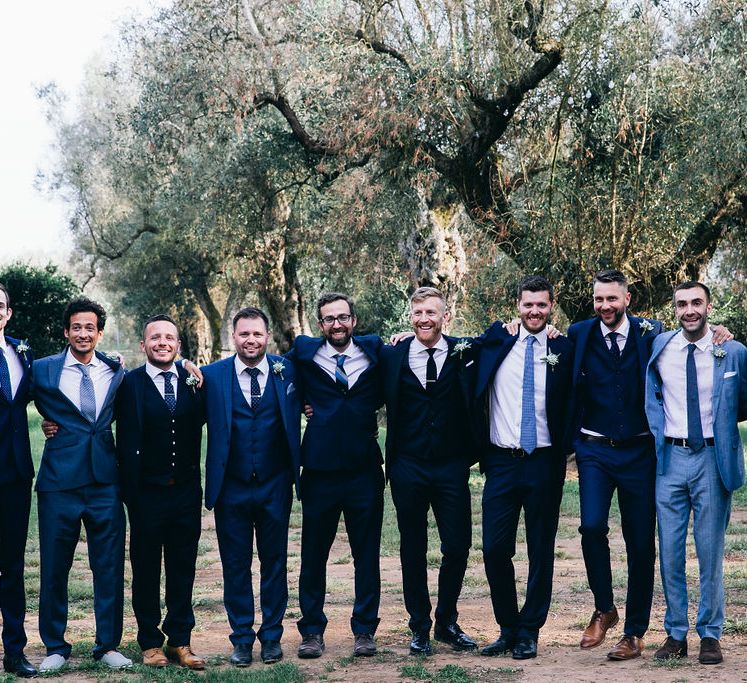 Groom in Dark Navy Hugo Boss Suit with Waistcoat and Black Patent Shoes by Common Projects | Groomsmen in Mismatched Navy Suits | Puglian Countryside Wedding with Fairy Light Altar and Olive Grove Aperitivo | Figtree Wedding Photography