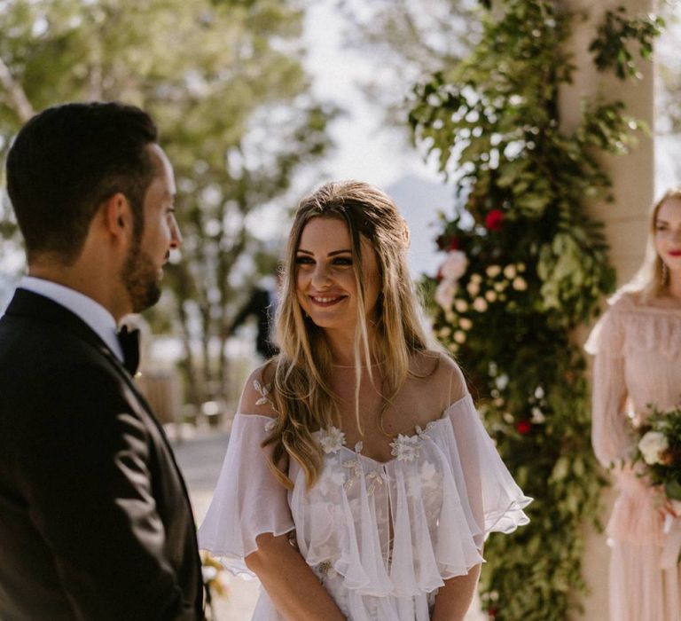 Bride Smiling at Her Groom At the Altar During The Wedding Ceremony