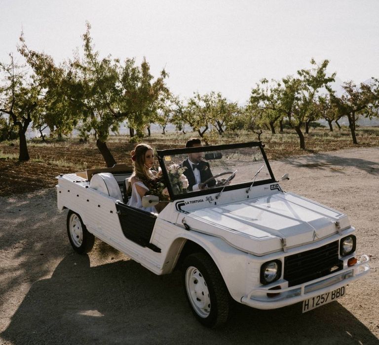 Bride and Groom Travelling in Their Jeep Wedding Car