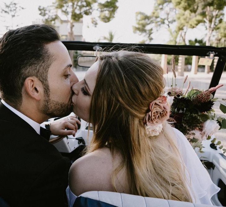 Bride and Groom Kissing in Their Jeep Wedding Car