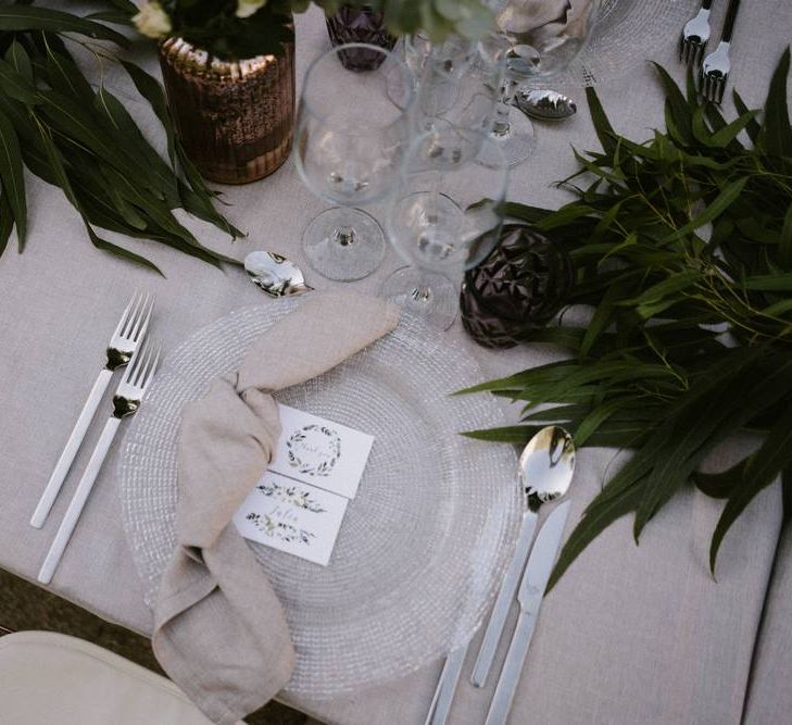 Place Setting with Folded Napkin on Glass Platter and Name Place Card