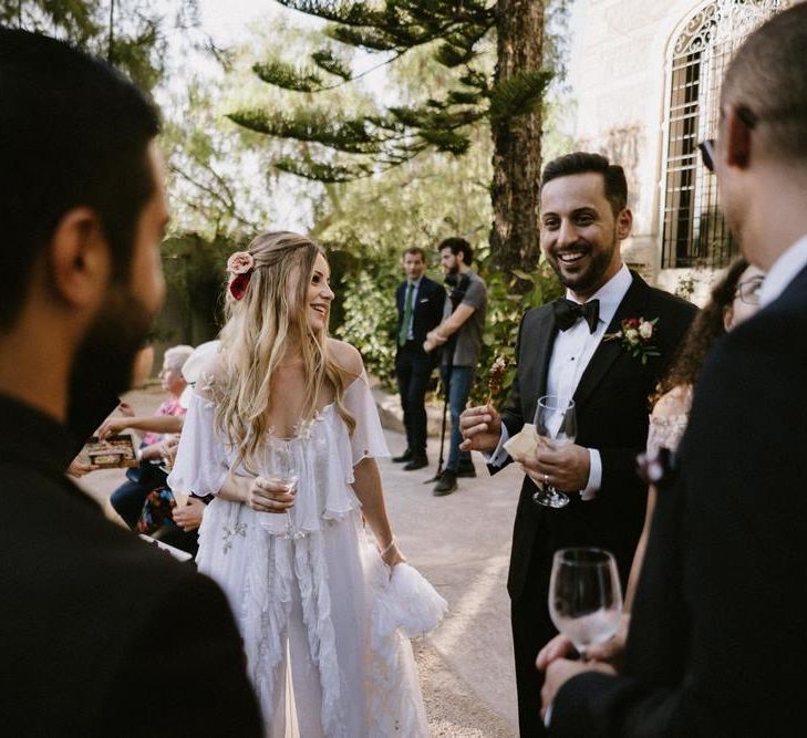 Bride and Groom Laughing with Their Guests