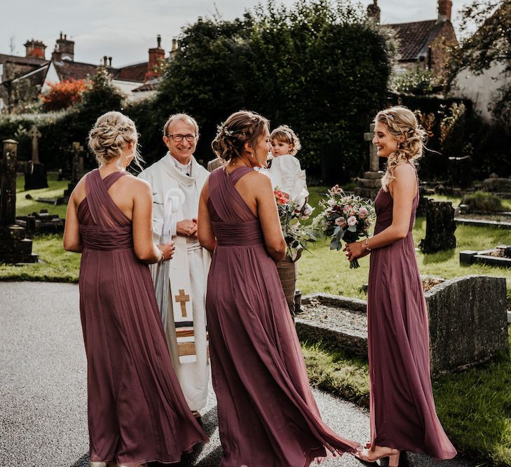 Bridal party outside the church in dusky pink dresses