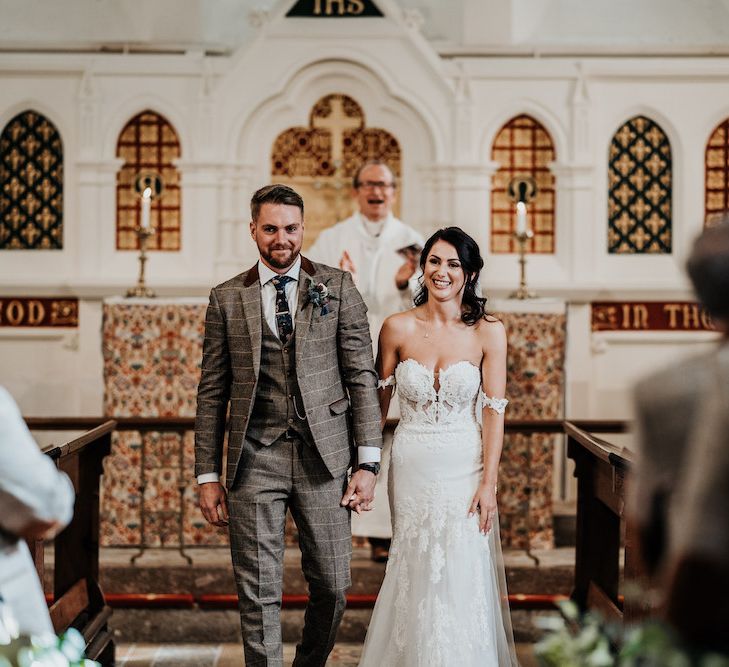 Bride and groom walking up the aisle as husband and wife