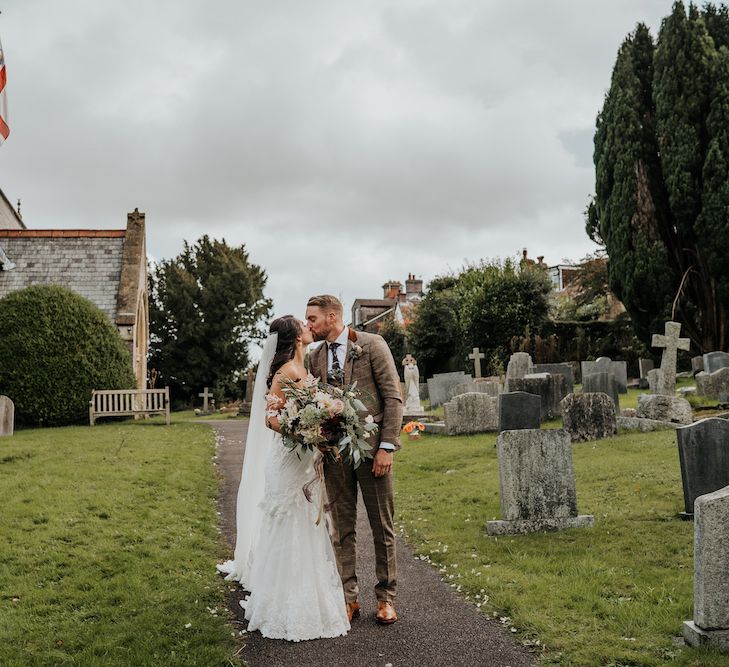 Bride and groom portrait in the church courtyard