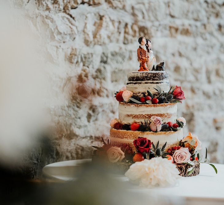 Semi naked wedding cake with bride and groom topper