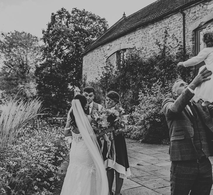 Wedding guests congregated outside Priston Mill