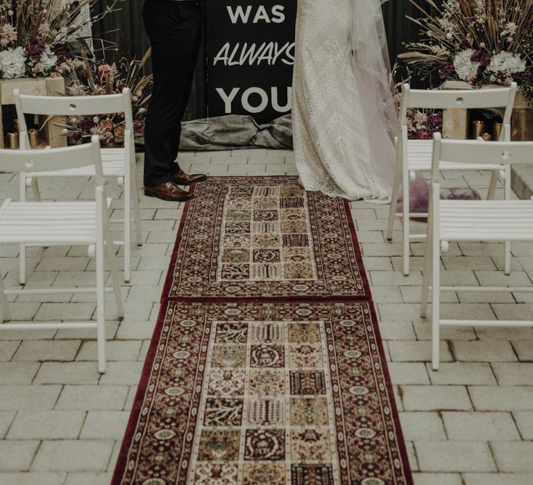 Boho Bride and Groom Standing at the Altar with Woven Rug, Bold Sign and Dried Flower Arrangements