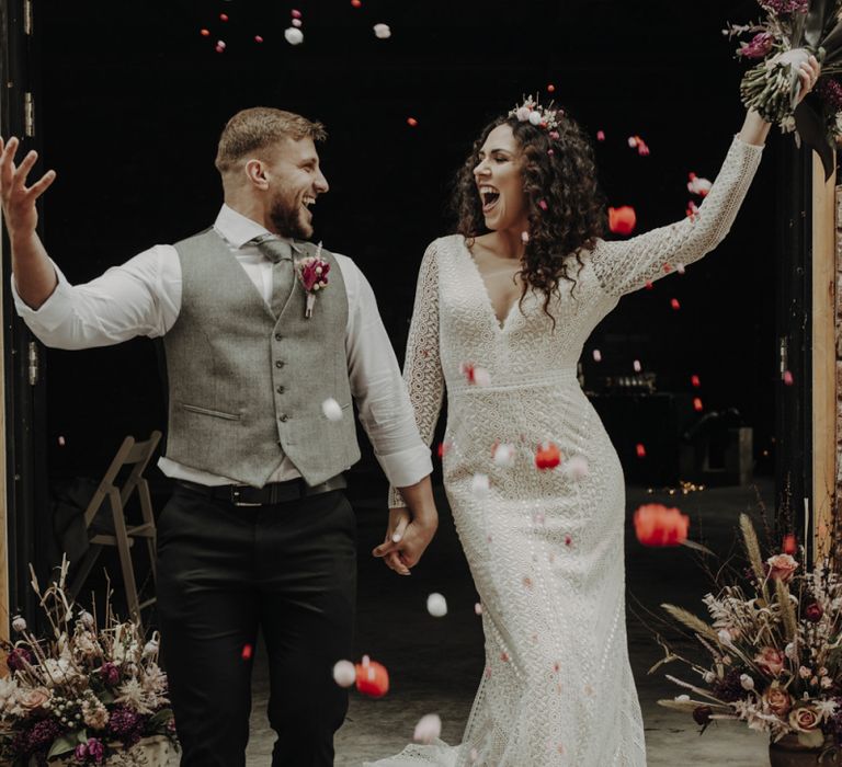 Confetti Moment with Bride in Lace Wedding Dress and Groom in Wool Waistcoat