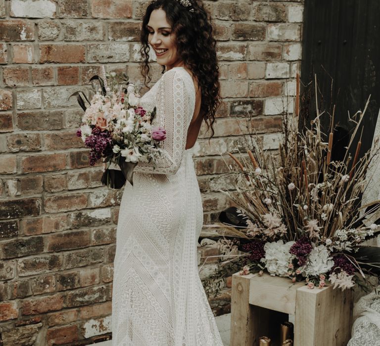 Boho Bride in Lace Wedding Dress Holding Dried Flower Bouquet