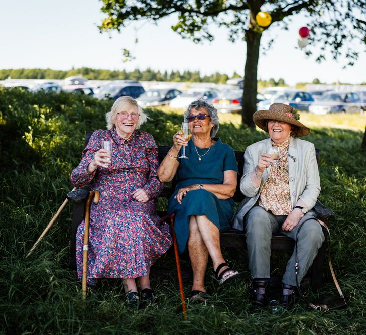 Wedding Guests Sitting on a Bench