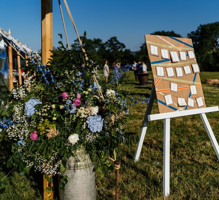 Pastel Wild Flowers in Milk Churn and Table Plan on Easel