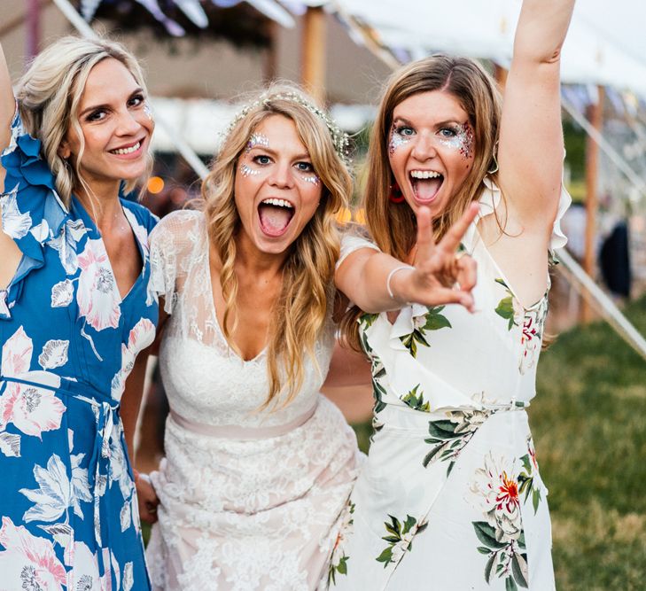 Bride in Lace Essense of Australia Wedding Dress and Bridesmaid in Blue Floral Dress from French Connection with Glitter Face Paint