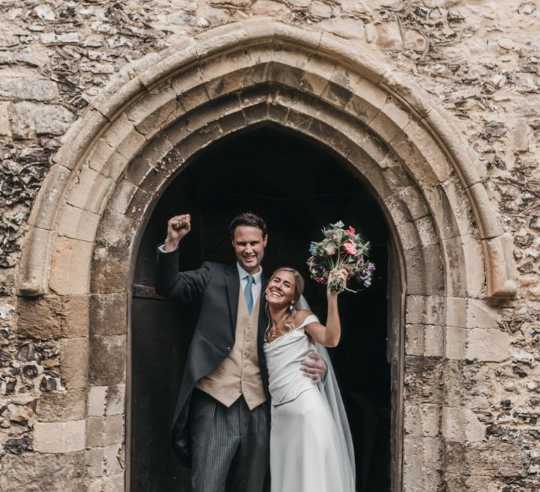 Bride and groom exit the church wedding ceremony as husband and wife