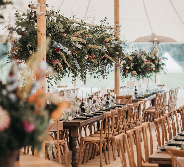 Wild flower installation above wooden tables