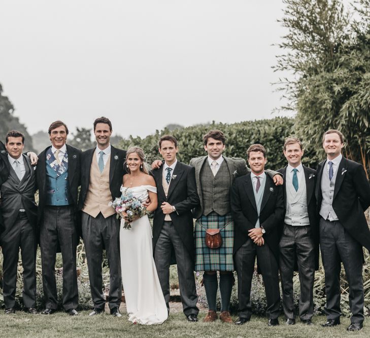 Groomsmen in different traditional morning suits for church wedding