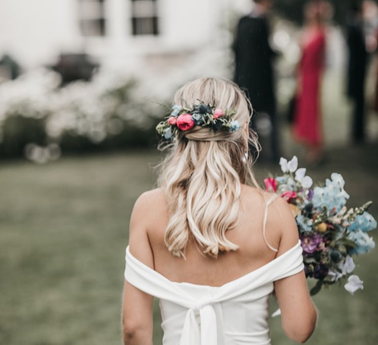 Half up half down wedding hair with fresh flowers for church wedding