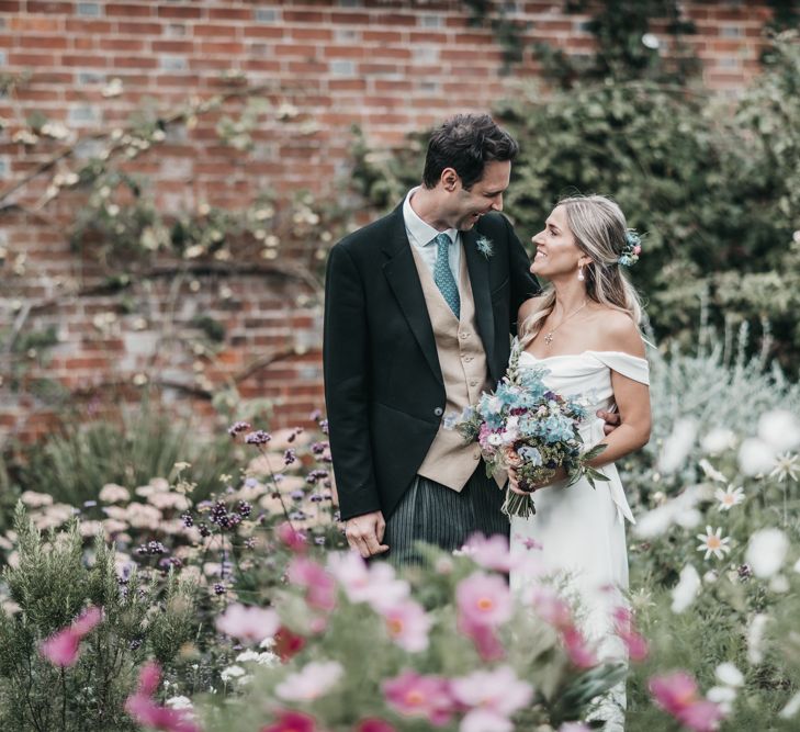 Bride and groom portrait amongst a wildflower garden