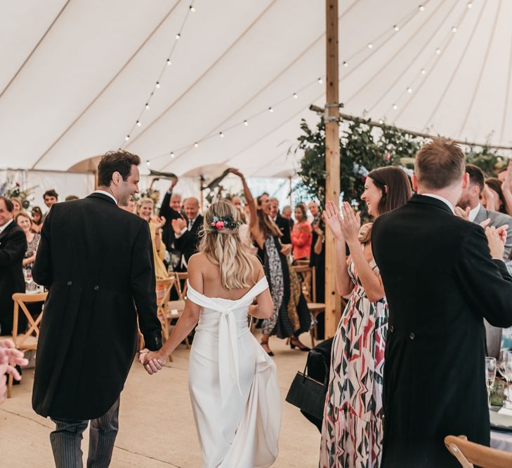 Bride and groom entering their PapaKata Sperry tent reception