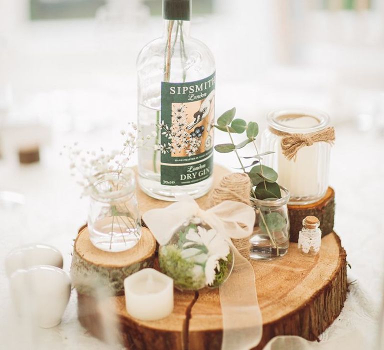 Rustic Centrepiece with Flowerstem in Gin Bottle