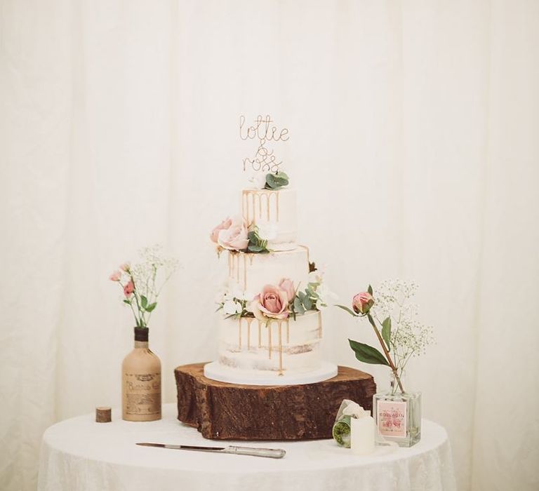 Tiered Drip Wedding Cake Surrounded by Flowerstem in Bottles