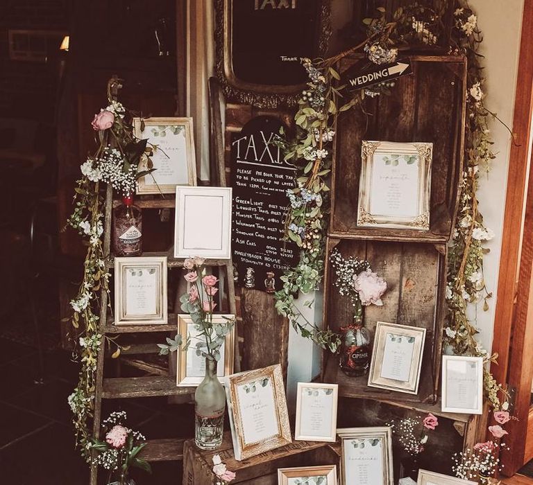 Rustic DIY Table Plan with Photoframes with Flowerstems in Bottles