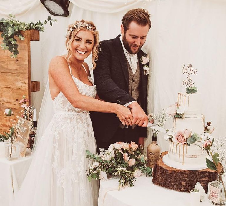 Drip Wedding Cake with Floral Decoration on Tree Trunk Slice