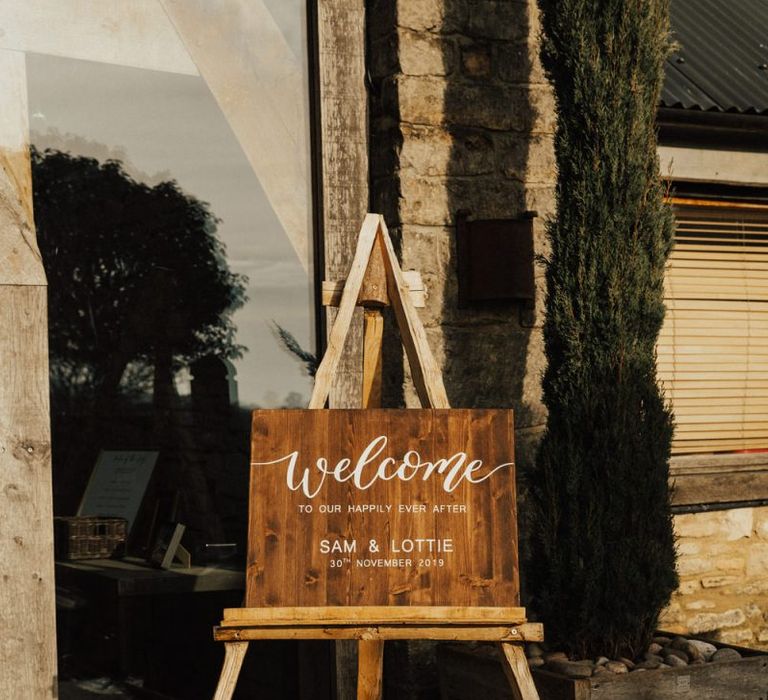 Wooden welcome sign at November wedding