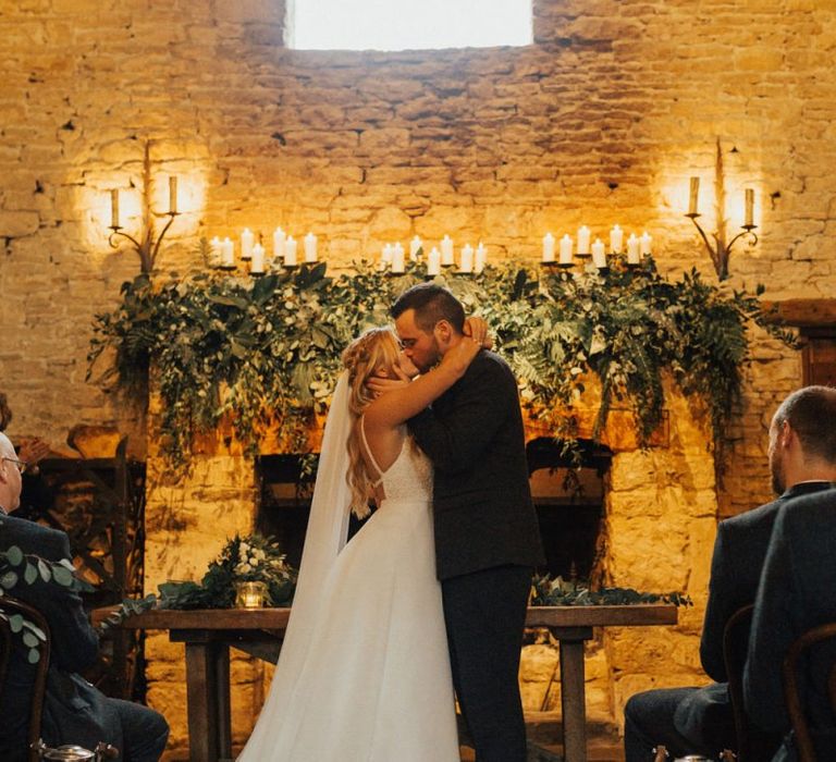 Cripps Barn fireplace wedding decor with foliage and candles