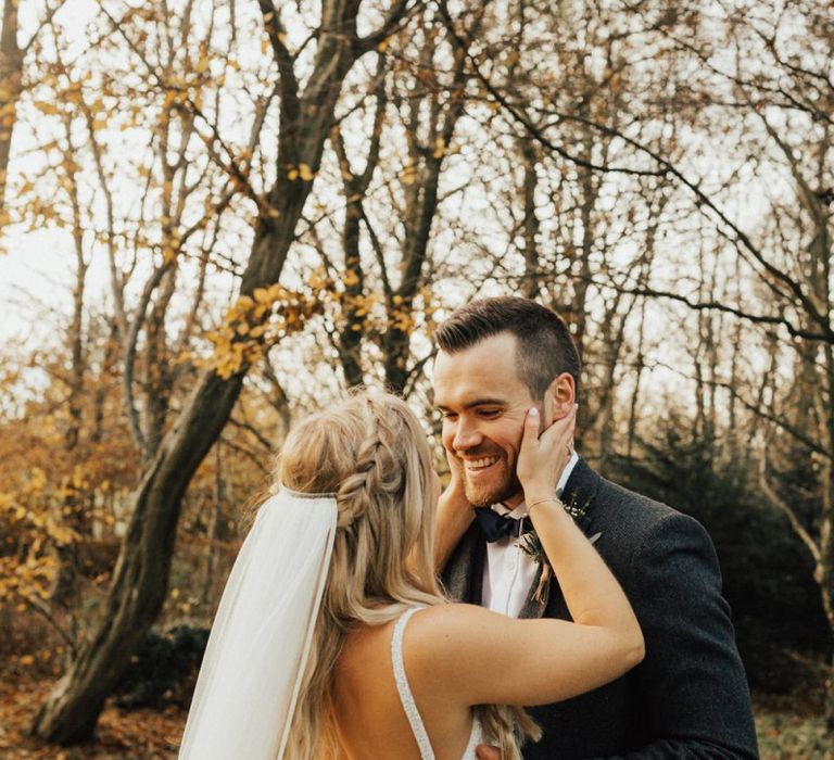 Intimate bride and groom portrait with bride in low back dress