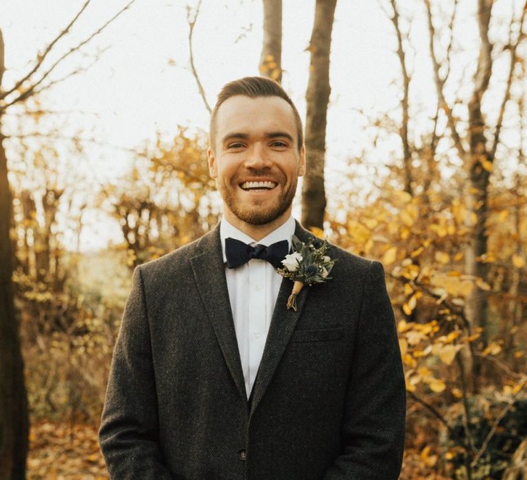 Groom in wool suit and bow tie for November wedding