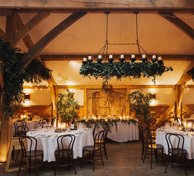 Cripps barn wedding reception with foliage and candles