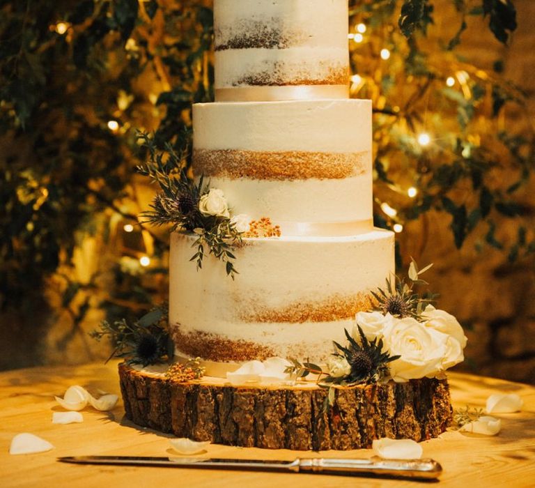 Semi naked wedding cake on tree stump cake stand