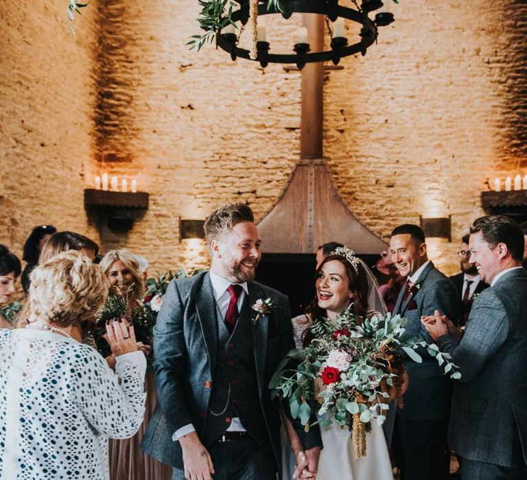 Bride and groom walking up aisle