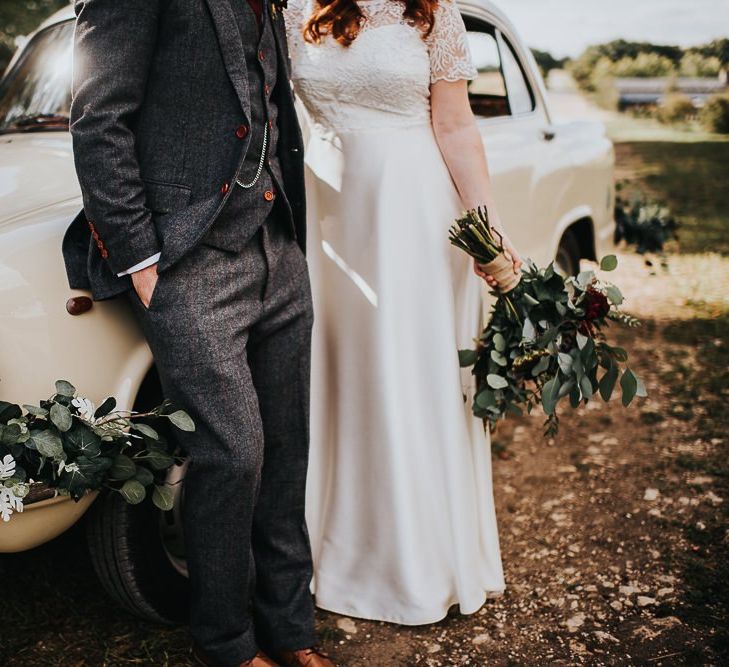 Wildflower wedding bouquet and wedding car foliage decor